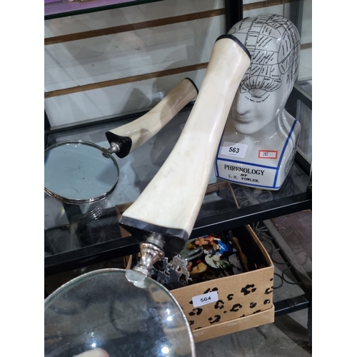 A pair of large magnifying glasses having bone style handles and a ...