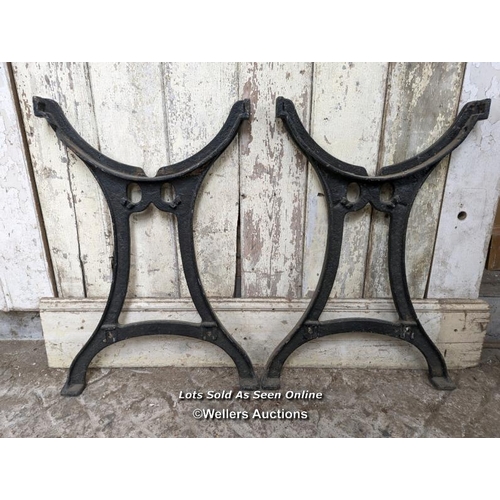 107 - Pair of metal table ends. Cast iron, 74cm H x approx 50cm W