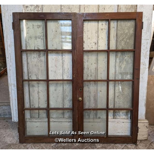 125 - Pair glazed cupboard doors and three solid cupboard doors. All pine. One piece of glass missing. Pai... 