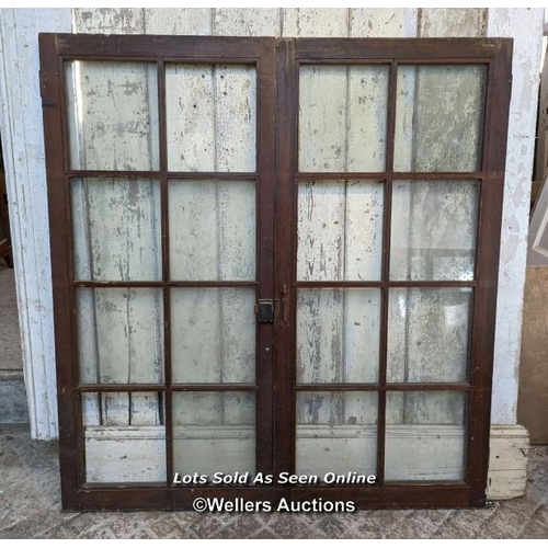 125 - Pair glazed cupboard doors and three solid cupboard doors. All pine. One piece of glass missing. Pai... 