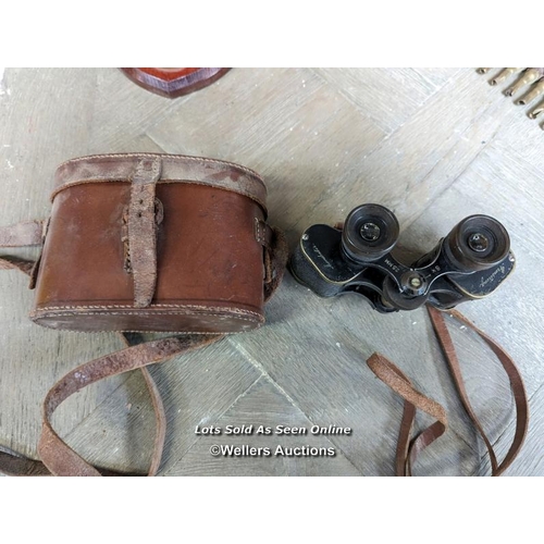 142 - Mixed military lot. Pair of binoculars in a leather case. A belt of machine gun bullets 1974. Defens... 