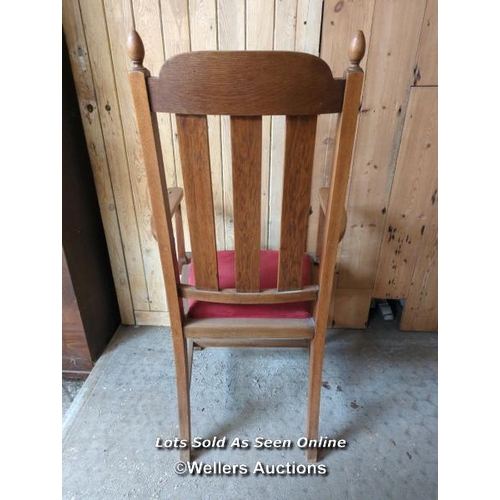 15 - Oak arts and crafts carved high back chair. Cushion seat. 113cm high. Good condition