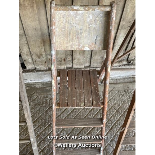 156 - 3 ladders. 2 wooden step ladders and a timber straight ladder 294cm tall