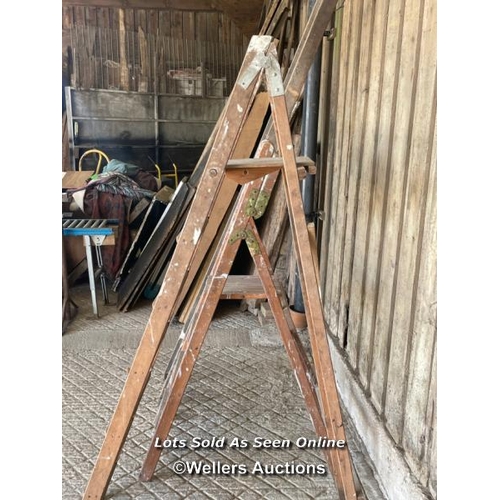 156 - 3 ladders. 2 wooden step ladders and a timber straight ladder 294cm tall