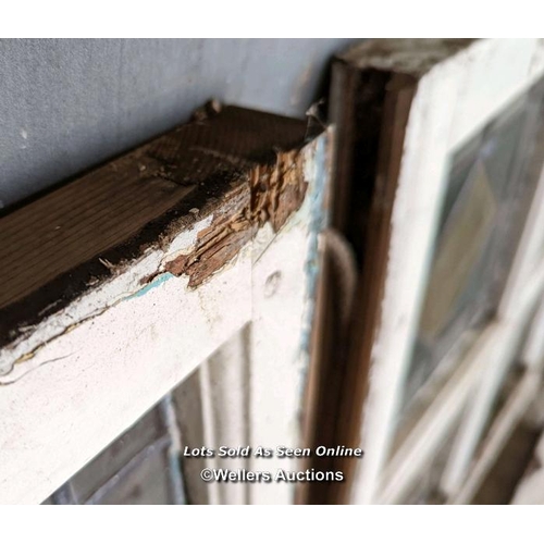 18 - 9 stained glass panels in pine frames from a sash window. Some breaks in the glass. Approx size each... 