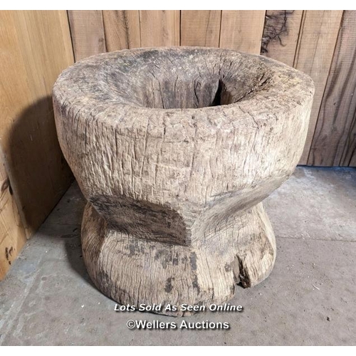 48 - A very large grain mortar. West African. Hardwood. The lid (75cm across) had a hole, now patched in ... 