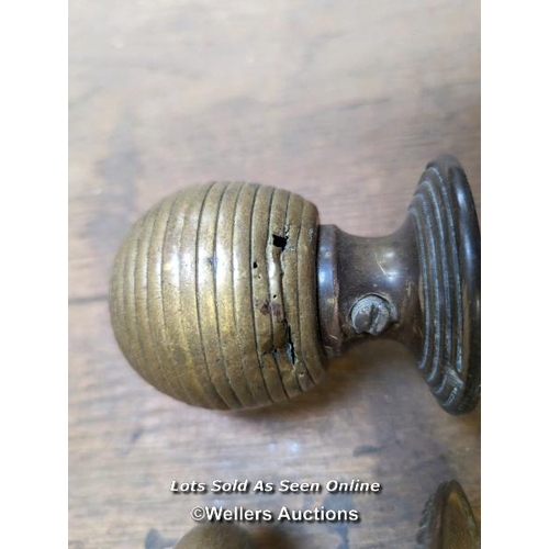 256 - 3 reclaimed brass front door pulls with holding bolts. Beehive pull with wear and tear.