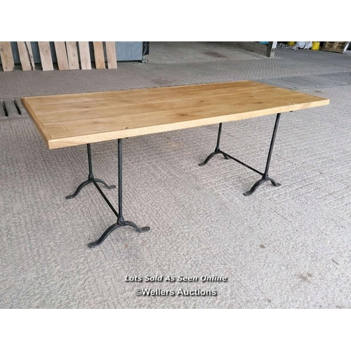 272 - A table with a pair of Victorian cast iron trestles and a new oak top. 203cm L x 82cm W x 76cm T. To... 