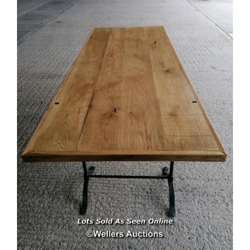 272 - A table with a pair of Victorian cast iron trestles and a new oak top. 203cm L x 82cm W x 76cm T. To... 