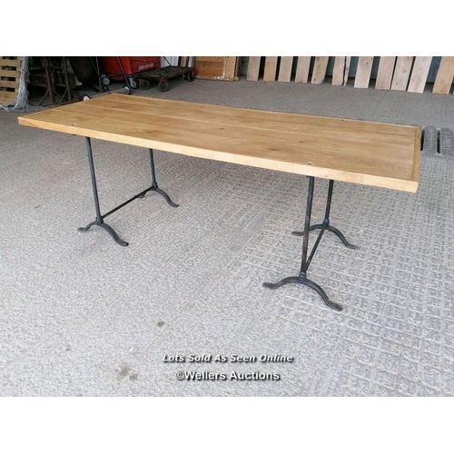 272 - A table with a pair of Victorian cast iron trestles and a new oak top. 203cm L x 82cm W x 76cm T. To... 