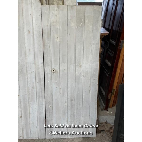 282 - 3 painted pine planked cupboard doors. Sizes 2 at 67.5cm x 167cm. 1 at 60cm x 196cm