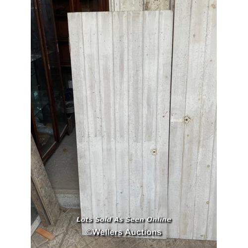 282 - 3 painted pine planked cupboard doors. Sizes 2 at 67.5cm x 167cm. 1 at 60cm x 196cm