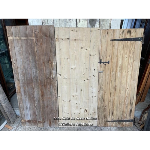 283 - 3 stripped pine plank cottage style doors. Sizes 72cm x 182cm. 70cm x 179cm. 67cm by 176cm