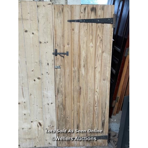 283 - 3 stripped pine plank cottage style doors. Sizes 72cm x 182cm. 70cm x 179cm. 67cm by 176cm