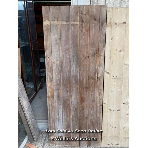 283 - 3 stripped pine plank cottage style doors. Sizes 72cm x 182cm. 70cm x 179cm. 67cm by 176cm