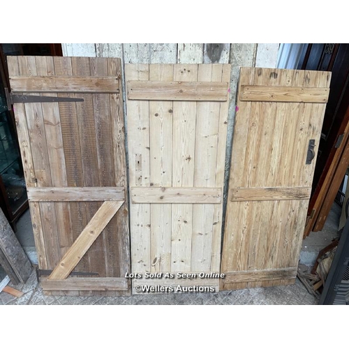 283 - 3 stripped pine plank cottage style doors. Sizes 72cm x 182cm. 70cm x 179cm. 67cm by 176cm