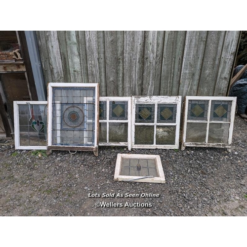 303 - 6 stained glass panels in pine frames. Some damage to glass and frames