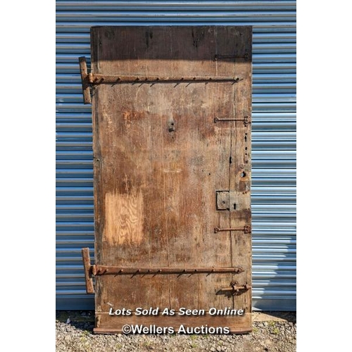 313 - Very large pine Castle door. Pine paneled face with oak back panel. Large cast iron hinges. Size 111... 