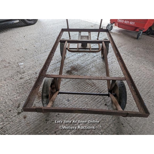 317 - Vintage trolley on wheels with solid rubber tyres. All wheels turning, front axle. Angle iron frame ... 