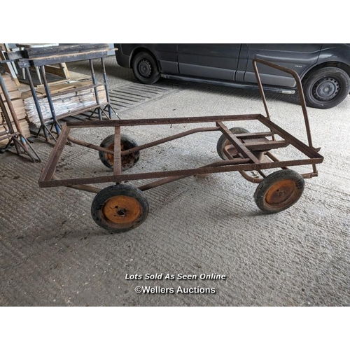 317 - Vintage trolley on wheels with solid rubber tyres. All wheels turning, front axle. Angle iron frame ... 