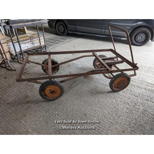 317 - Vintage trolley on wheels with solid rubber tyres. All wheels turning, front axle. Angle iron frame ... 