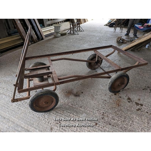 317 - Vintage trolley on wheels with solid rubber tyres. All wheels turning, front axle. Angle iron frame ... 