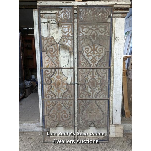 354 - Pair of slim metal doors with handpainted stained glass. Some losses. Some small fragments included.