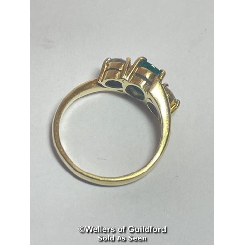 340 - An emerald and diamond three stone ring in crossover style. Emerald measures approx 6.9 x 5.1 x 3.5m... 