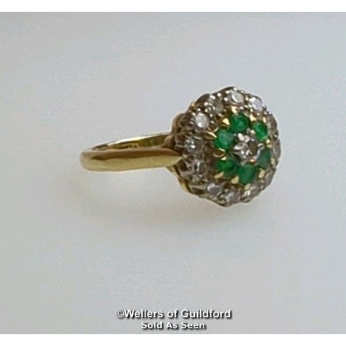 367 - Emerald and diamond round cluster ring in hallmarked 18ct gold. Central brilliant cut diamond estima... 