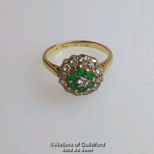 367 - Emerald and diamond round cluster ring in hallmarked 18ct gold. Central brilliant cut diamond estima... 