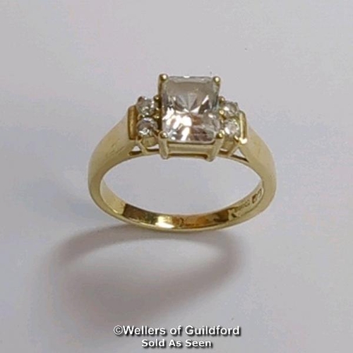 377 - A cubic zirconia dress ring in hallmarked 14ct gold. The emerald cut centre stone measures 7mm x 5.1... 