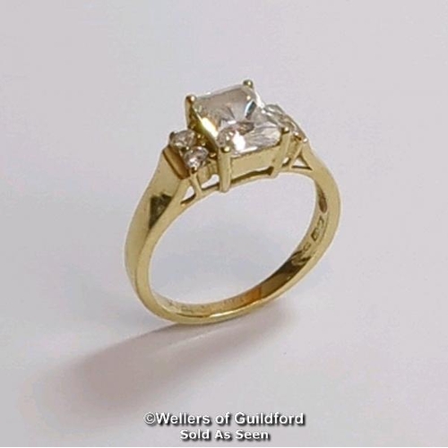 377 - A cubic zirconia dress ring in hallmarked 14ct gold. The emerald cut centre stone measures 7mm x 5.1... 