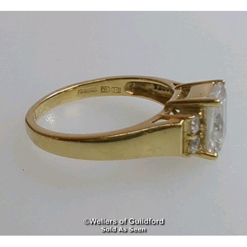 377 - A cubic zirconia dress ring in hallmarked 14ct gold. The emerald cut centre stone measures 7mm x 5.1... 