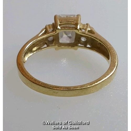 377 - A cubic zirconia dress ring in hallmarked 14ct gold. The emerald cut centre stone measures 7mm x 5.1... 