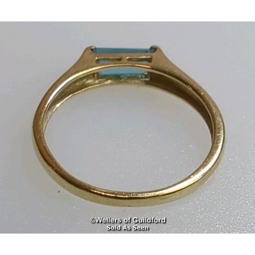 380 - Blue topaz (untested) single stone ring in hallmarked 9ct gold, by QVC. The baguette cut stone measu... 