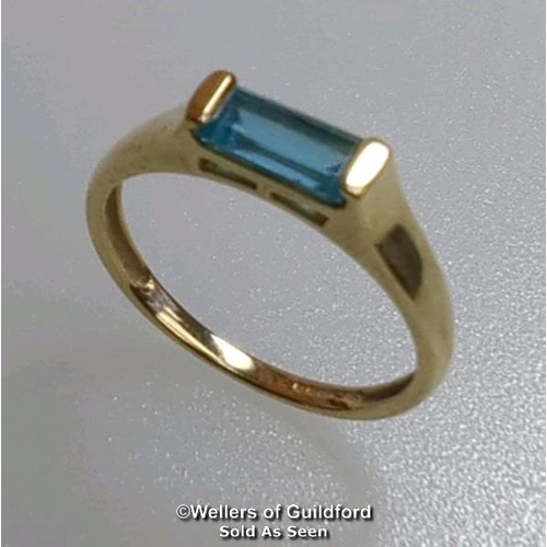 380 - Blue topaz (untested) single stone ring in hallmarked 9ct gold, by QVC. The baguette cut stone measu... 