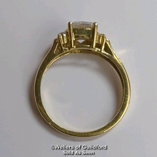 377 - A cubic zirconia dress ring in hallmarked 14ct gold. The emerald cut centre stone measures 7mm x 5.1... 