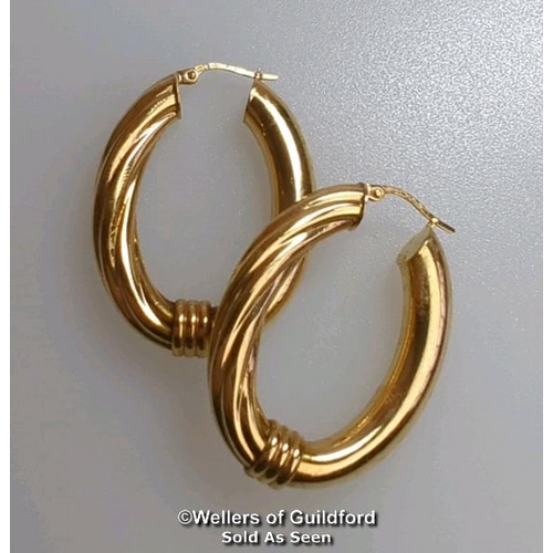 374 - A pair of oval hoop earrings in hallmarked 9ct gold, length 4cm, gross weight 6.83g