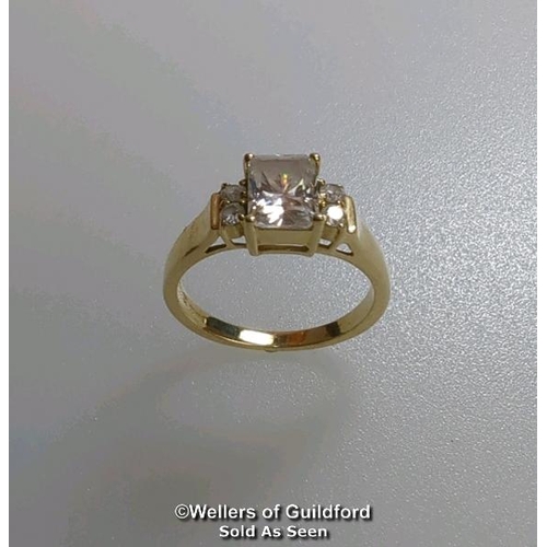 377 - A cubic zirconia dress ring in hallmarked 14ct gold. The emerald cut centre stone measures 7mm x 5.1... 