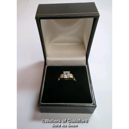 377 - A cubic zirconia dress ring in hallmarked 14ct gold. The emerald cut centre stone measures 7mm x 5.1... 