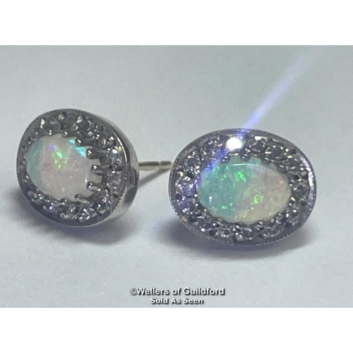 395 - A pair of oval opal and diamond cluster earings in hallmarked 9ct gold. Opals measure approx 7mm x 5... 