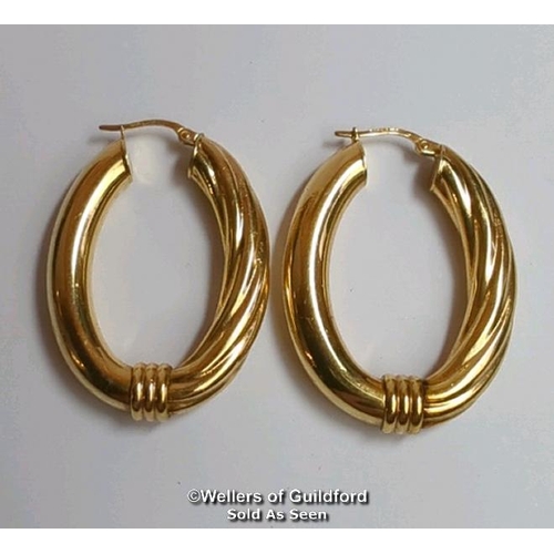 374 - A pair of oval hoop earrings in hallmarked 9ct gold, length 4cm, gross weight 6.83g