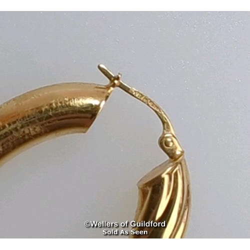 374 - A pair of oval hoop earrings in hallmarked 9ct gold, length 4cm, gross weight 6.83g