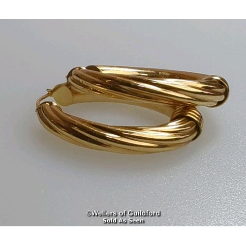 374 - A pair of oval hoop earrings in hallmarked 9ct gold, length 4cm, gross weight 6.83g