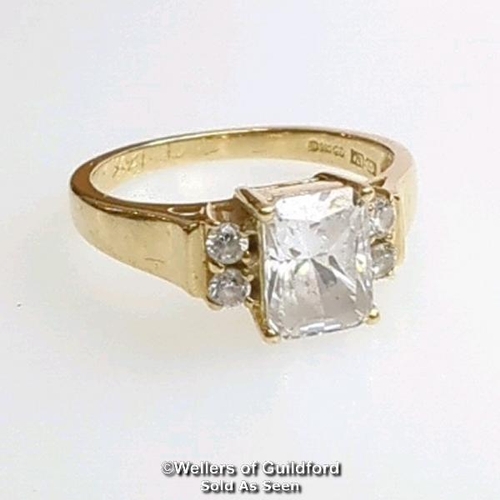 377 - A cubic zirconia dress ring in hallmarked 14ct gold. The emerald cut centre stone measures 7mm x 5.1... 