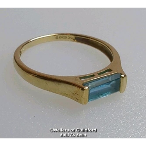 380 - Blue topaz (untested) single stone ring in hallmarked 9ct gold, by QVC. The baguette cut stone measu... 