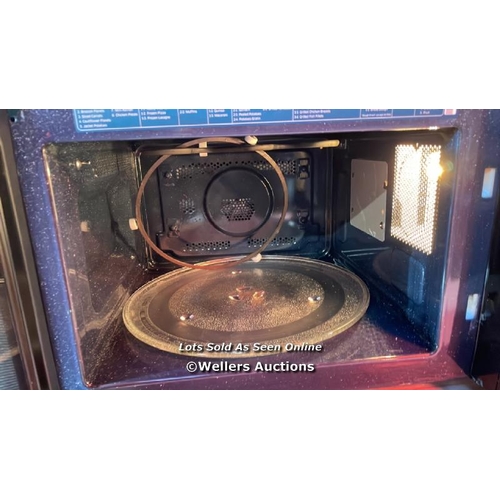 7052 - SAMSUNG MICROWAVE ( S/N 0C9Q7WFR500352R) / POWERS UP / SIGNS OF USE / DENTED / G12