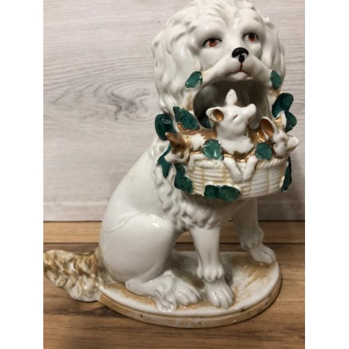 38 - A pair of German porcelain Poodle dogs with baskets containing piglets,  19cm high / AN8