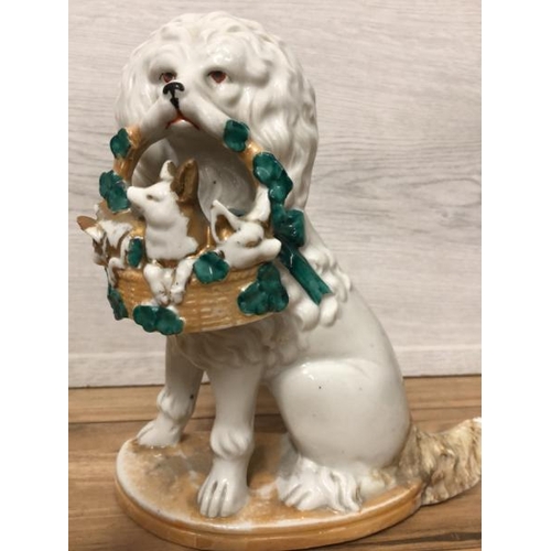 38 - A pair of German porcelain Poodle dogs with baskets containing piglets,  19cm high / AN8