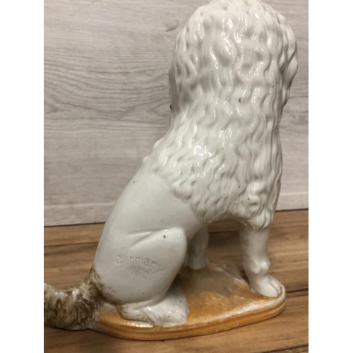 38 - A pair of German porcelain Poodle dogs with baskets containing piglets,  19cm high / AN8